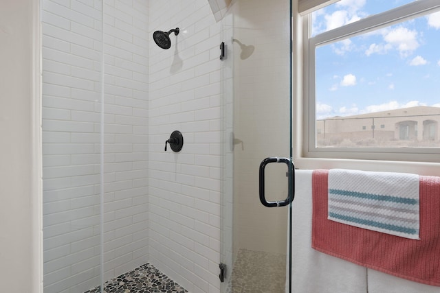 bathroom featuring a shower with door