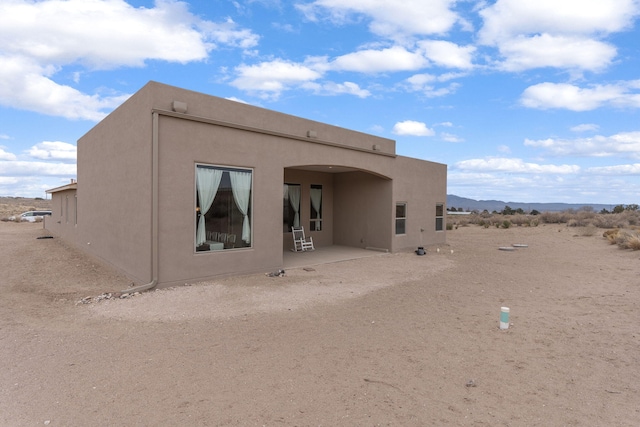 back of house with a patio area