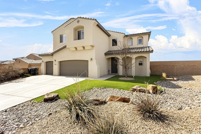 mediterranean / spanish house with a tile roof, stucco siding, fence, a garage, and driveway