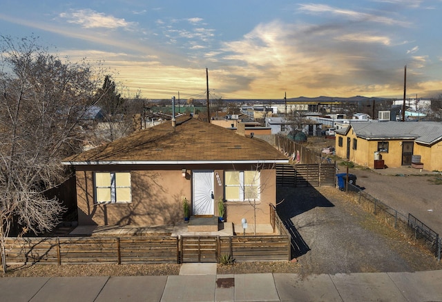 view of front of property featuring a fenced front yard and stucco siding