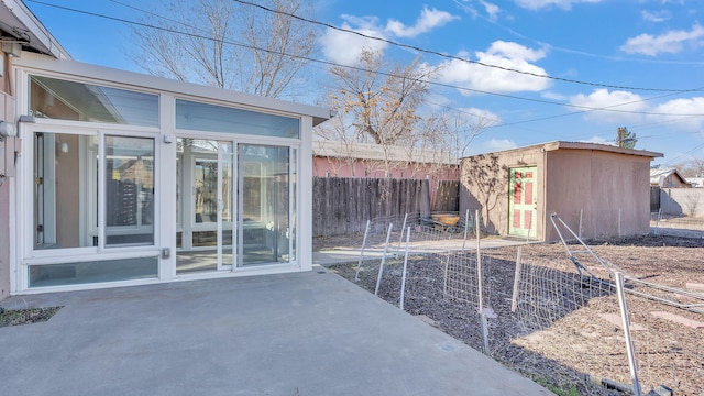 exterior space featuring a storage shed, an outdoor structure, and fence