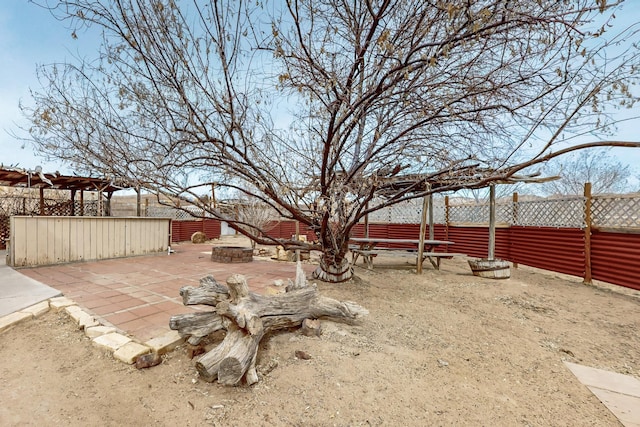 view of yard with an outdoor fire pit, a patio, and fence private yard