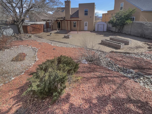 6737 Gleason Ave NW, Albuquerque, NM 87120 - view of yard featuring a patio area, a fenced backyard, an outdoor structure, and a storage shed