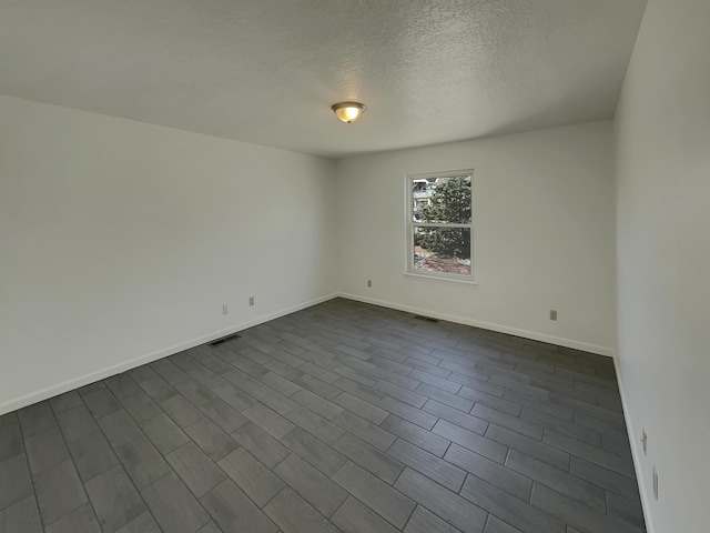 6737 Gleason Ave NW, Albuquerque, NM 87120 - empty room with visible vents, baseboards, and a textured ceiling