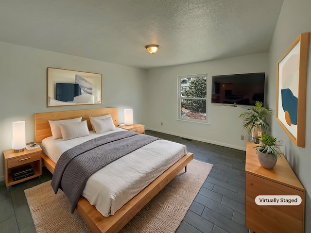 6737 Gleason Ave NW, Albuquerque, NM 87120 - bedroom featuring visible vents, dark wood finished floors, a textured ceiling, and baseboards