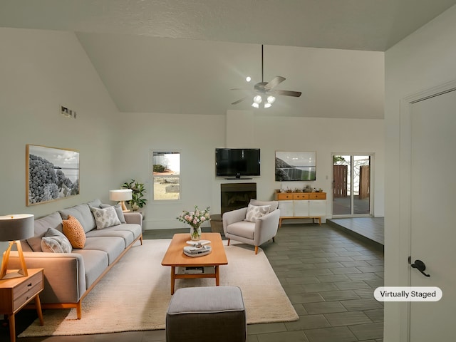 6737 Gleason Ave NW, Albuquerque, NM 87120 - living room with high vaulted ceiling, a fireplace, visible vents, and a ceiling fan