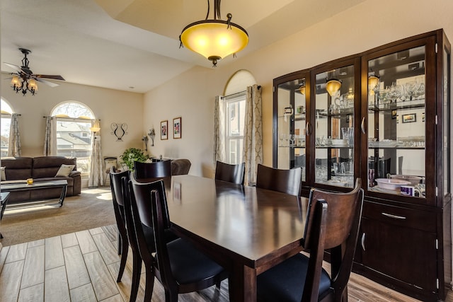 dining area with ceiling fan and light wood-style floors