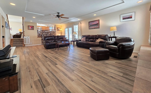 living room with baseboards, visible vents, stairway, wood finished floors, and recessed lighting