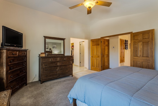 bedroom with lofted ceiling, light colored carpet, ceiling fan, and a spacious closet