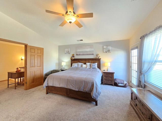 bedroom with light colored carpet, visible vents, vaulted ceiling, and ceiling fan