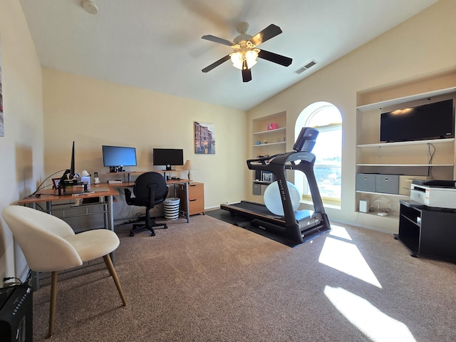 carpeted office space featuring built in features, visible vents, vaulted ceiling, ceiling fan, and baseboards