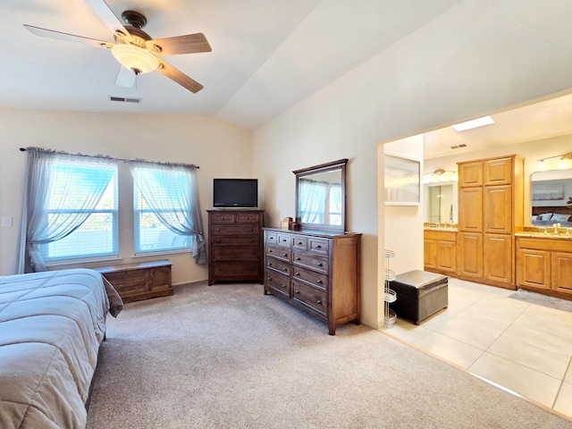 bedroom featuring vaulted ceiling, multiple windows, visible vents, and light colored carpet