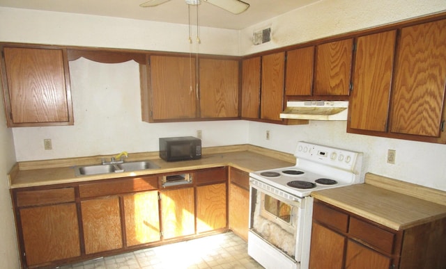 kitchen featuring white range with electric stovetop, light countertops, a sink, black microwave, and under cabinet range hood