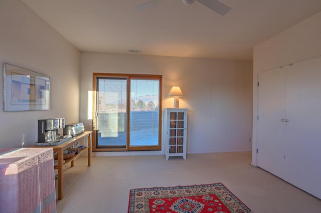 office space with carpet floors, visible vents, and a ceiling fan