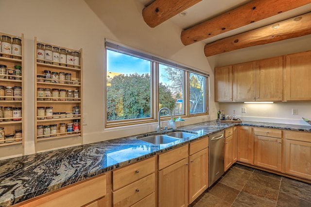 kitchen with beam ceiling, stainless steel dishwasher, light brown cabinets, a sink, and dark stone countertops