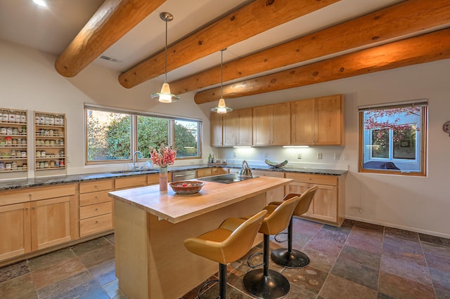 5524 Poblanos Ct NW, Albuquerque, NM 87107 - kitchen with butcher block counters, light brown cabinets, dishwasher, stone tile flooring, and beam ceiling