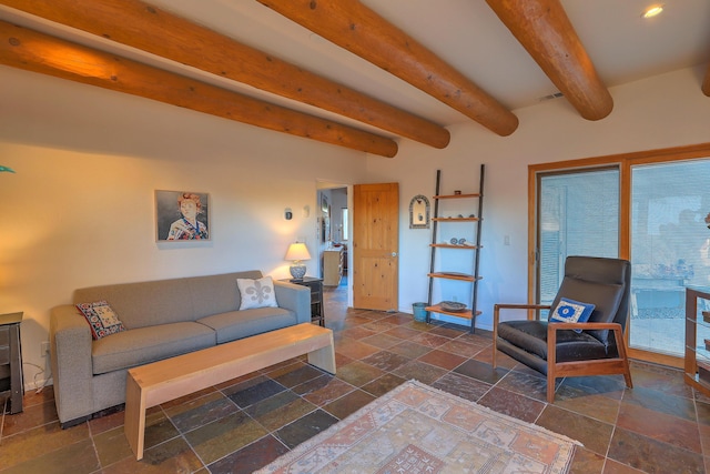 living area with stone tile floors, baseboards, and beam ceiling