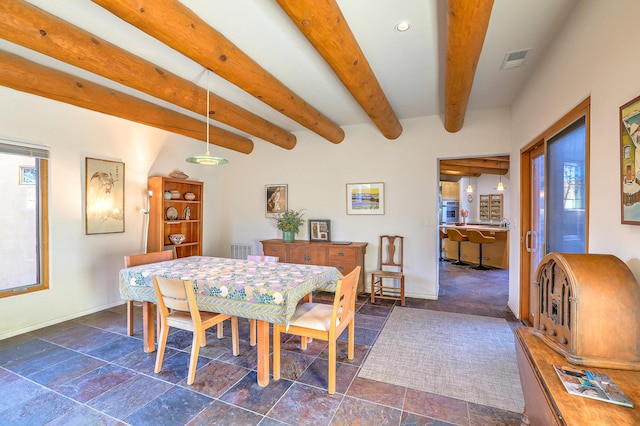 dining space featuring baseboards, beamed ceiling, visible vents, and stone tile floors