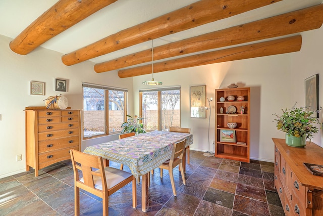 dining area with baseboards, beamed ceiling, and stone tile floors