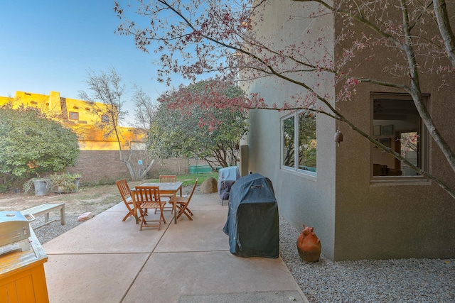 view of patio with outdoor dining space, area for grilling, and a fenced backyard