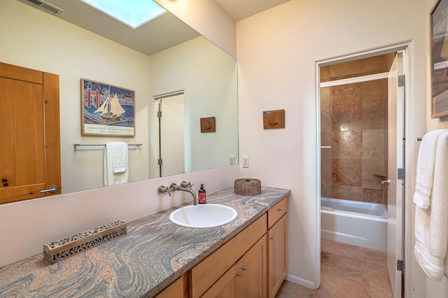 bathroom with a skylight, visible vents, vanity, shower / tub combination, and tile patterned floors