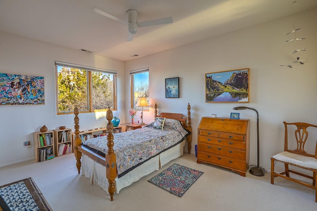 carpeted bedroom with a ceiling fan and visible vents