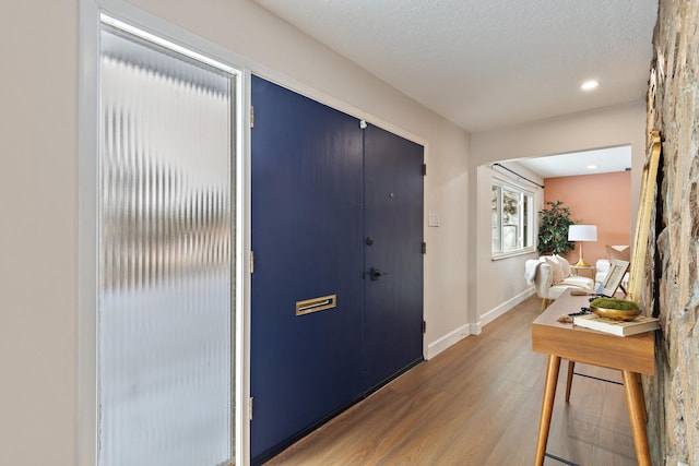 foyer entrance with a textured ceiling and hardwood / wood-style floors