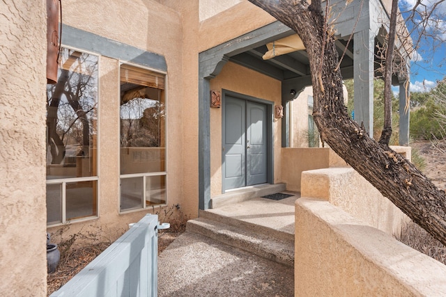 doorway to property with stucco siding