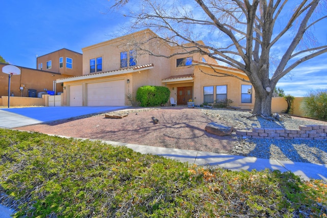 view of front of house featuring a garage, a tile roof, fence, concrete driveway, and stucco siding