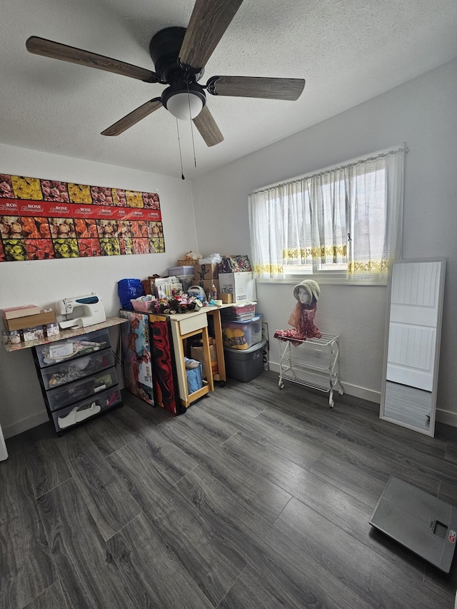 interior space featuring dark wood-style flooring, a textured ceiling, and baseboards