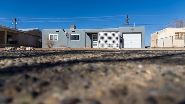 view of front facade with an attached garage and stucco siding