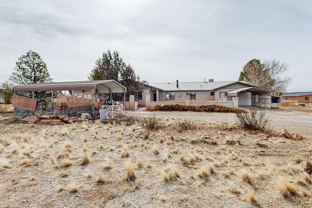 single story home featuring a carport