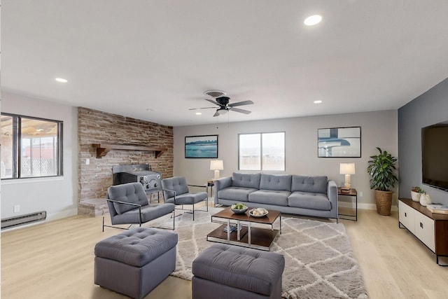 living area with baseboards, light wood finished floors, a baseboard radiator, and recessed lighting