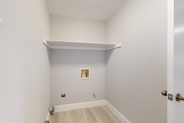 laundry room with laundry area, light wood finished floors, hookup for a washing machine, and baseboards