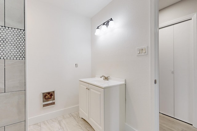 bathroom featuring marble finish floor, baseboards, and vanity