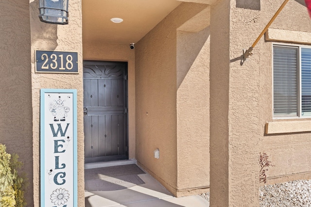 doorway to property with stucco siding