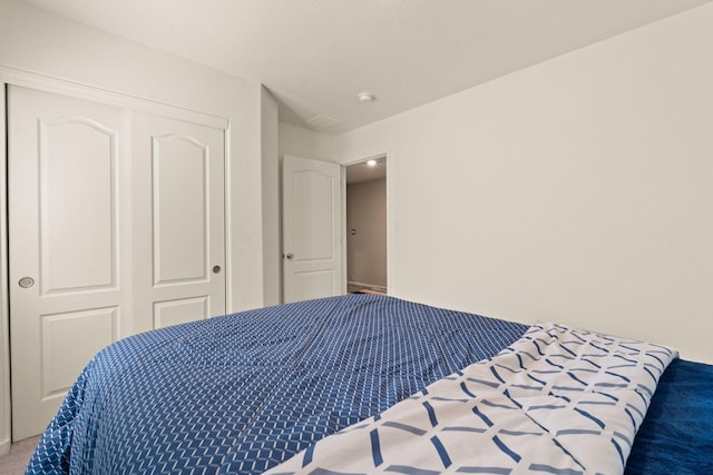 bedroom with carpet floors and a closet