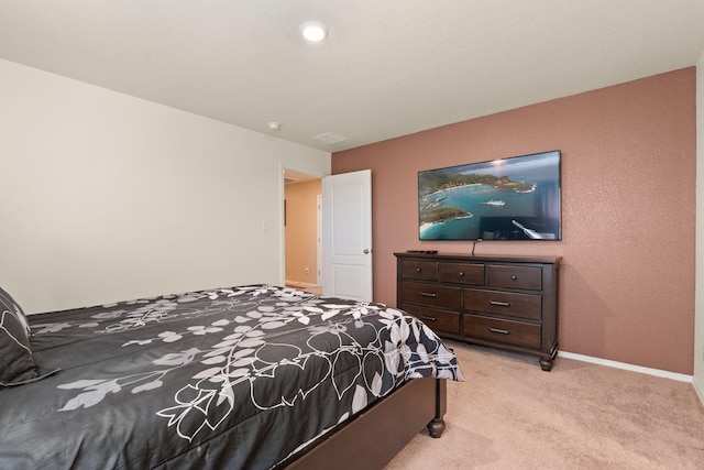 bedroom with baseboards and light colored carpet