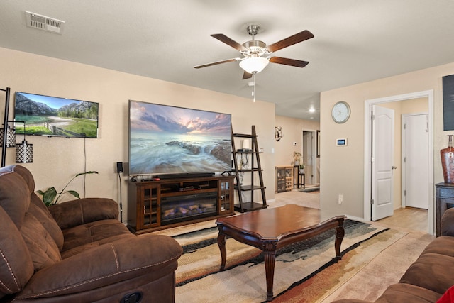 living area with visible vents and a ceiling fan