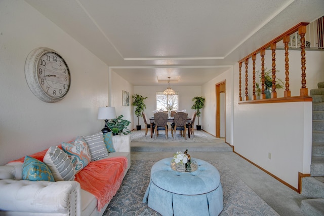 carpeted living room featuring stairs, a raised ceiling, and baseboards