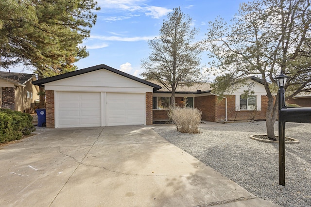 ranch-style home with an attached garage, driveway, and brick siding