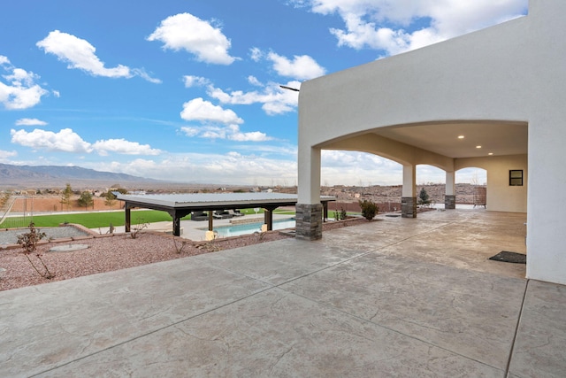 6316 La Paz Rd NE, Rio Rancho, NM 87144 - view of patio featuring an outdoor pool and a mountain view