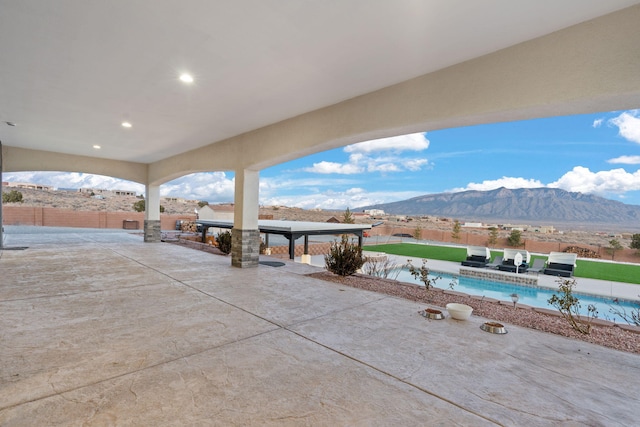 6316 La Paz Rd NE, Rio Rancho, NM 87144 - fenced backyard featuring a patio and a mountain view