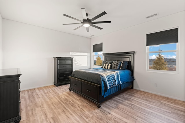 6316 La Paz Rd NE, Rio Rancho, NM 87144 - bedroom with light wood-style flooring, multiple windows, baseboards, and a ceiling fan