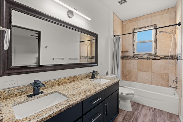 6316 La Paz Rd NE, Rio Rancho, NM 87144 - bathroom featuring double vanity, shower / bath combo with shower curtain, toilet, and wood finished floors
