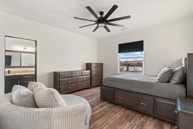 6316 La Paz Rd NE, Rio Rancho, NM 87144 - bedroom featuring wood finished floors, ensuite bathroom, and a ceiling fan