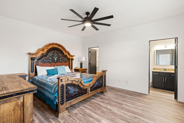 6316 La Paz Rd NE, Rio Rancho, NM 87144 - bedroom with light wood finished floors, a sink, and ensuite bath