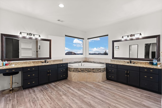 6316 La Paz Rd NE, Rio Rancho, NM 87144 - bathroom featuring wood finished floors, a garden tub, and two vanities