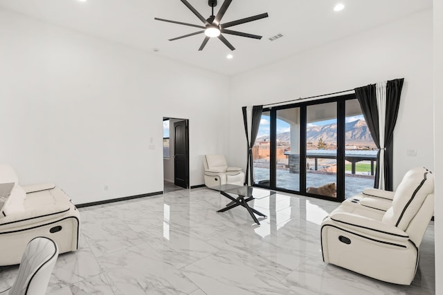 6316 La Paz Rd NE, Rio Rancho, NM 87144 - living room with ceiling fan, light marble finish flooring, baseboards, recessed lighting, and a towering ceiling
