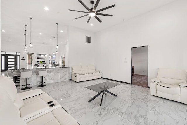 6316 La Paz Rd NE, Rio Rancho, NM 87144 - living area featuring a ceiling fan, light marble finish floors, and recessed lighting